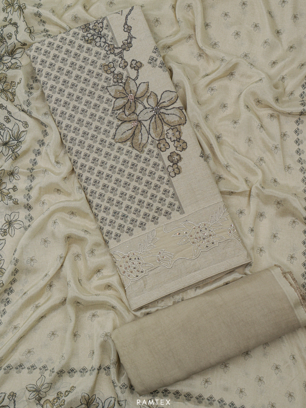Textured fabric with floral patterns and a roll of fabric on a matching background, featuring the RAMTEX brand.
